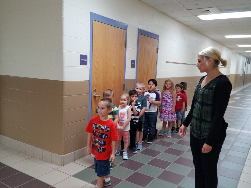 Teacher with students in hallway