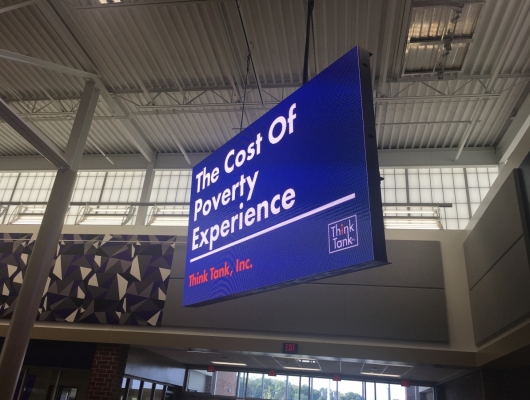 The Cost of Poverty Experience sign