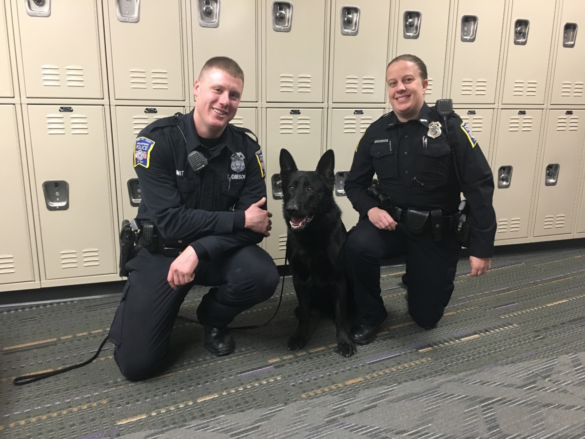 two police officers and dog