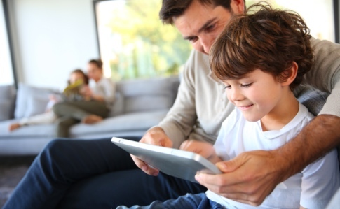 dad and son on tablet