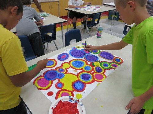 two kids painting circles