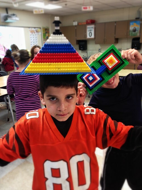 A boy with a lego triangle on his head
