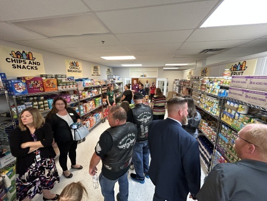 Group of corporate donators take tour of new food pantry