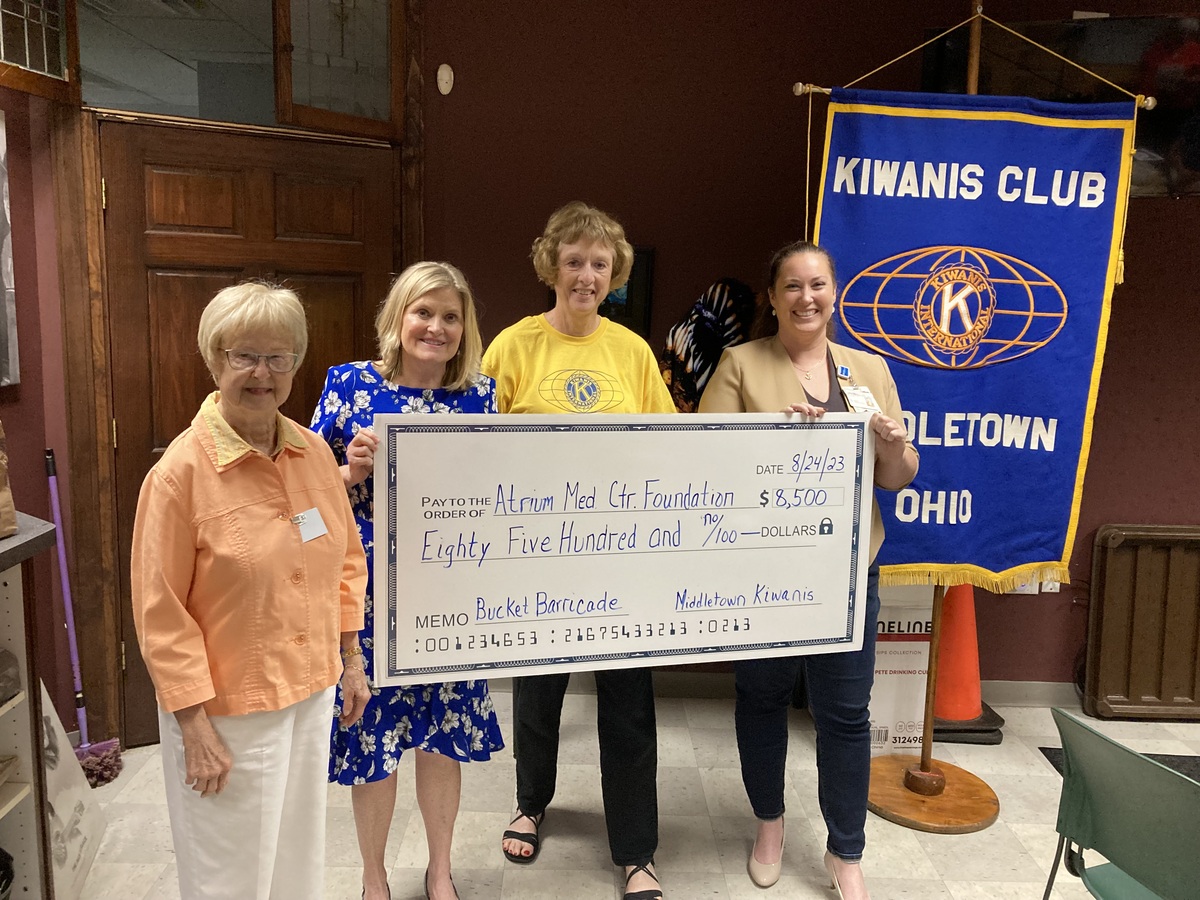 Four women hold up large check for Barricade Bucket Safety Project.