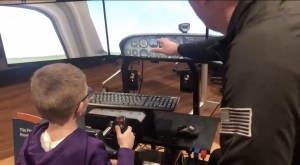 Student flying a flight simulator 
