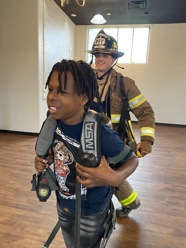 boy carrying fire equipment