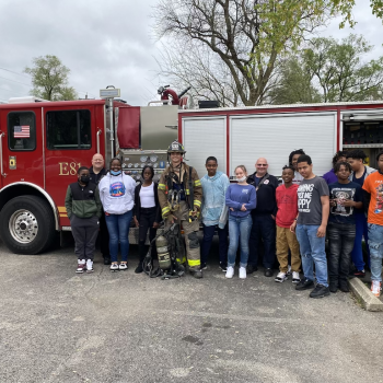 group in front of firetruck