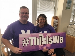 Two people holding a #ThisIsWe sign