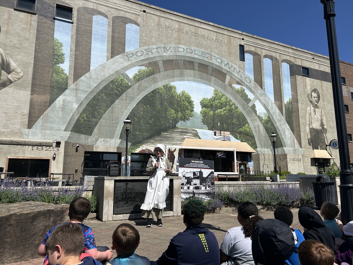 Photos of students outside canal mural in downtown Middletown