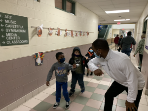 Marlon Styles elbow bumping young student