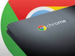 Chromebook corner of laptop with Chrome logo and Chrome logo enlarged in background