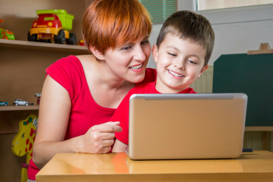 mom sitting with son on computer