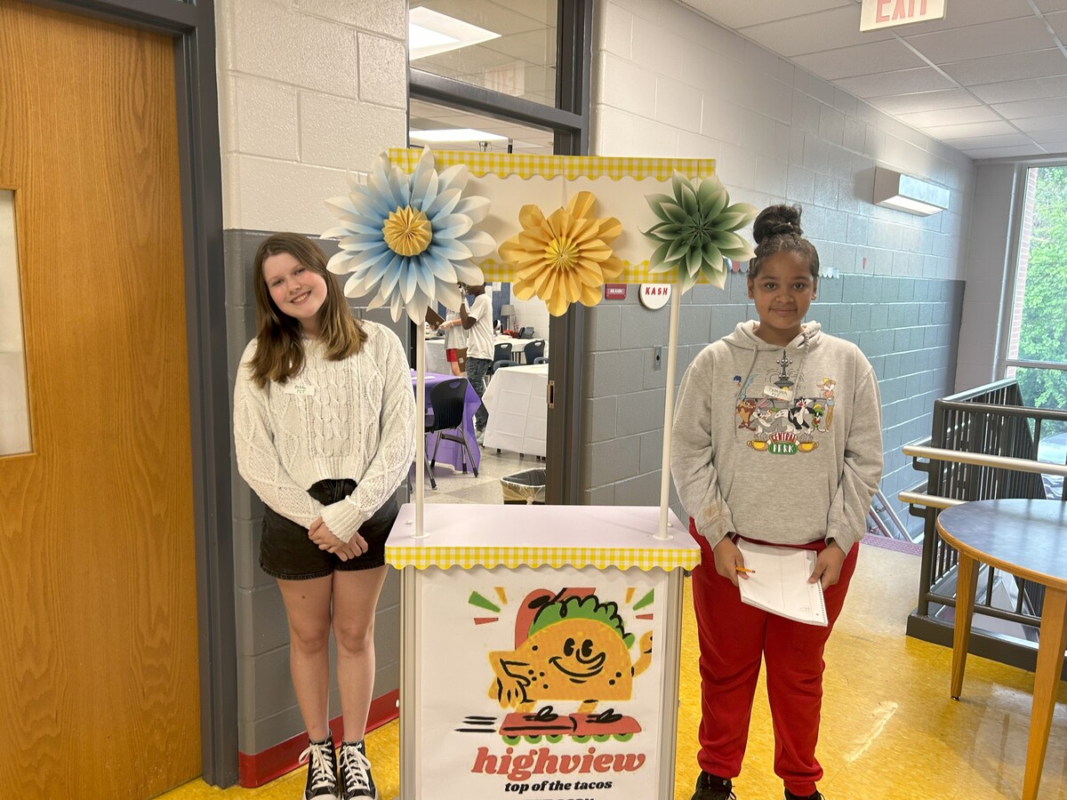 Students pose at their pop-up taco business, 'Highview Top of the Tacos.'